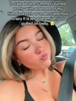 A selfie-style shot taken from inside a car, featuring a young woman with blonde-highlighted hair. She's wearing a black top and a necklace with a pendant. The woman has her eyes closed and her lips slightly puckered, with text overlayed at the top, describing what looks like a scene from 'The Summer I Turned Pretty'. The background shows a car interior.