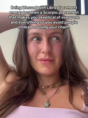 A woman with long brown hair and a light complexion is the central figure, captured from the chest up. She wears a light pink top. Her expression is a mix of thought and a slight smirk. The background is neutral, with a touch of light and shadow. Text overlay in white font provides additional context. The composition is simple, focusing on the woman's face and upper body.