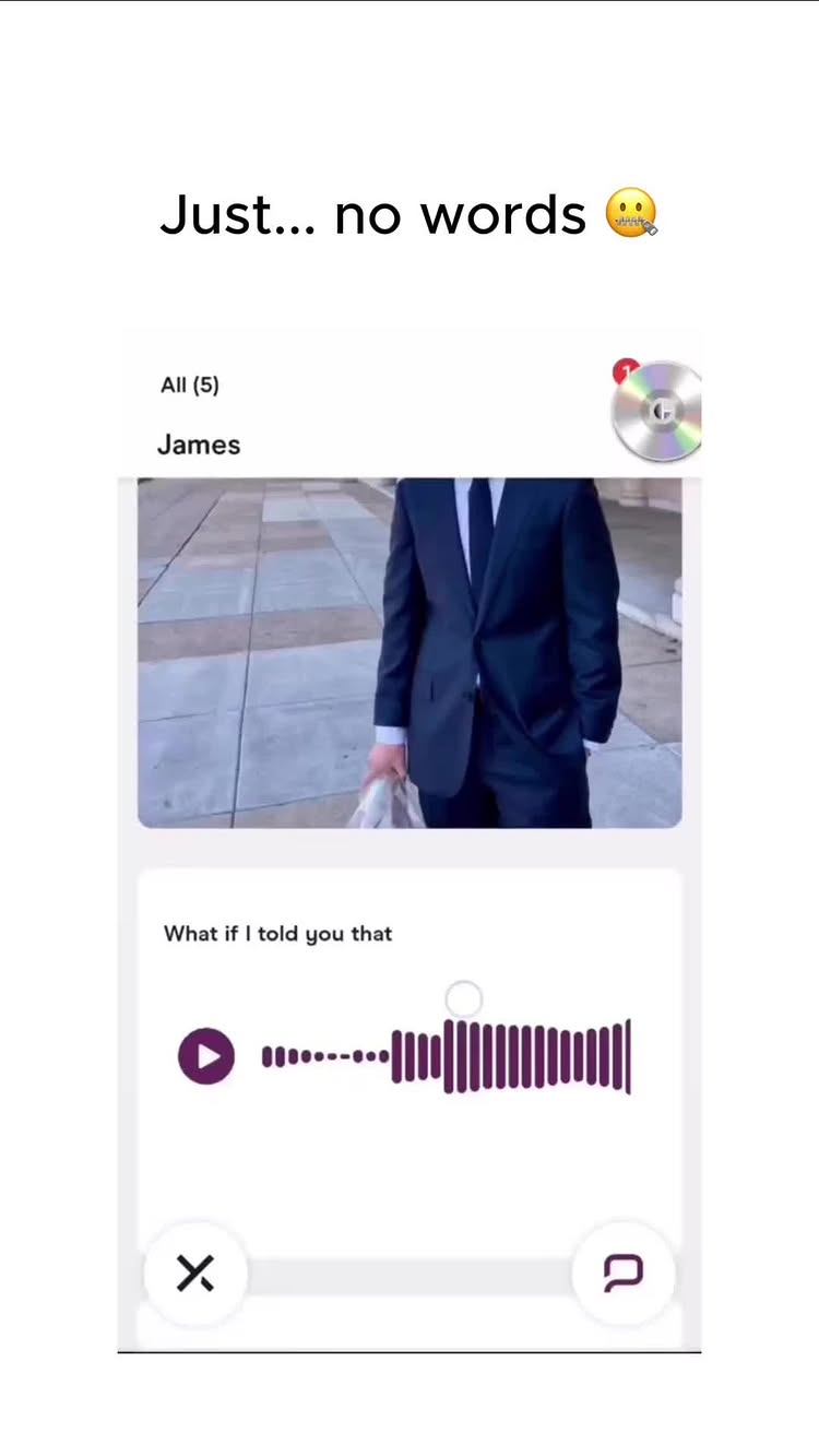 A dating app interface is shown mid-conversation. A man in a suit is captured on the upper portion of the screen, in the bottom portion the conversation is shown with the question "What if I told you that" and a purple play button with a red badge.