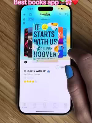 The cover image shows a smartphone displaying the Bookly app, showcasing several book covers, with the "It Starts With Us" by Colleen Hoover book prominently displayed. A hand with blue nail polish is partially visible, interacting with the phone.