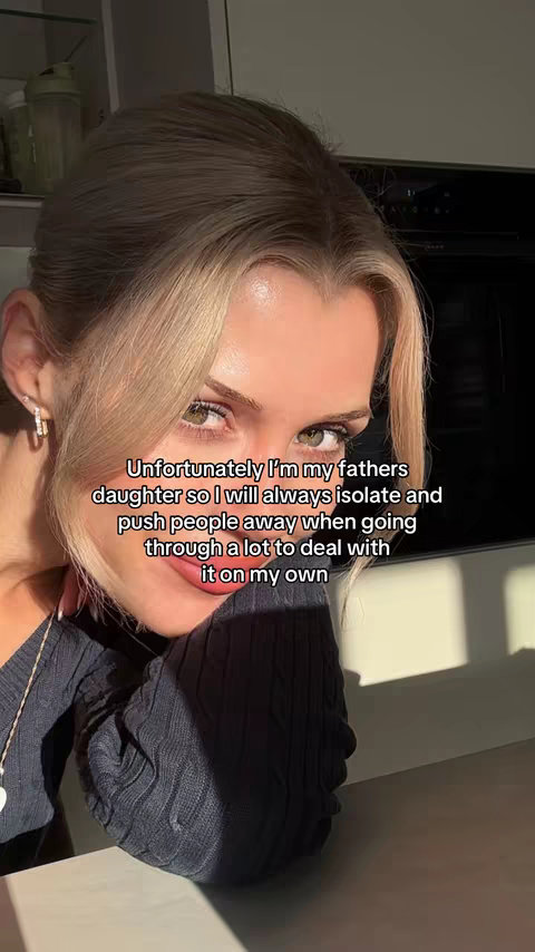 A woman with blonde hair, posed slightly angled to the camera. She is wearing a dark sweater. Text overlays the image.