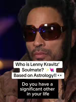 The image is a close-up portrait format, featuring Lenny Kravitz. He is seen from the chest up, wearing large, brown-tinted sunglasses. His expression is neutral. Text overlays are present at the bottom third of the frame.