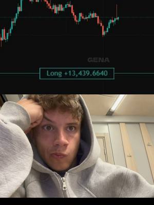 The image shows a young man looking directly at the camera with a concerned expression, overlaid with a stock market chart. The man has short, curly hair, is wearing a gray hoodie and is in a brightly lit room. Above the man, there's a chart with red and green lines, presumably representing stock market data. The chart is set against a black background, with data points and the text 'GENA' along the right and a text box that says 'Long +13,439.6640'.