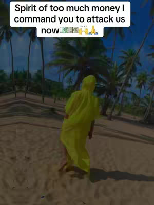 A person in a yellow hooded outfit walks away from the camera on a sandy beach. The background features palm trees and a blue sky, suggesting a tropical location. Text overlay is present at the top.