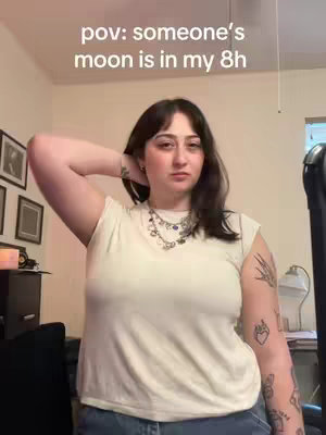 A person with long dark hair wearing no-sleeve white t-shirt and blue jeans stands in a room, with their right arm raised touching the head. Text overlay indicates the video's theme.