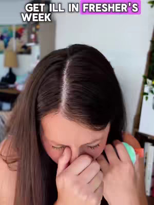 The cover image features a close-up of a person, likely the creator, with a focus on their face. Long, dark hair is parted down the middle.. They appear to be holding something up to their face, possibly a tissue or a small object.. The background is soft and out of focus, suggesting an indoor setting, and the overall image conveys a sense of concern or discomfort, possibly related to illness, as indicated by the overlay text.