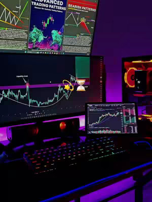 A desktop setup showcases multiple computer monitors displaying trading charts and patterns. The scene, bathed in purple ambient lighting, features a keyboard with illuminated keys, speakers, and additional screens displaying financial data and graphs related to trading.