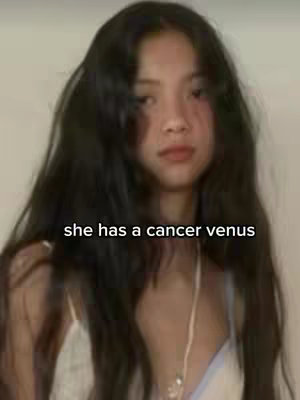 A portrait-style shot features a young woman with long, dark hair. She looks towards the camera with a neutral expression against a soft background. Text overlayed at the bottom reads, "she has a cancer venus."