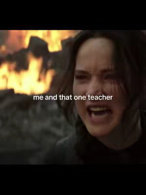 The cover image shows a close-up of a woman with dark hair, possibly Jennifer Lawrence, looking distraught with her mouth open and eyes wide as if about to cry or scream. Behind her is a blurred background of flames, suggesting a fire or explosion. The text overlay at the bottom of the image reads 'me and that one teacher' in white text.