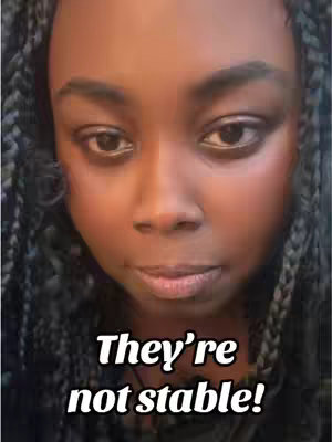 A close-up shot of a Black woman's face, framed in a vertical composition. The subject gazes at the camera with a neutral expression. She has dark skin and is wearing braided hair that frame her face. Bold text overlays the lower portion of the image.