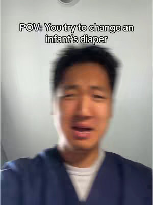 The cover image features a close-up shot of a young man with a slightly blurred appearance. He is wearing a dark blue top and has a light-colored background. Text overlay at the top reads, 'POV: You try to change an infant's diaper'. His expression suggests a feeling of stress or discomfort.