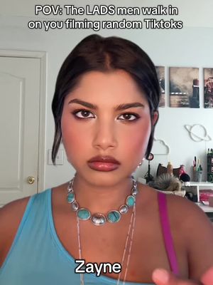 A woman with dark hair and makeup looks at the camera. The text overlay says, 'POV: The LADS men walk in on you filming random TokToks'. A 'Zayne' text is at bottom center.