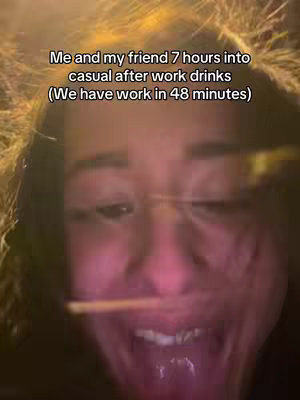 A close-up shot features a person's face, with the focus on the mouth. The person appears to be smiling widely. The surrounding is blurred, indicating a possible night setting, with the background appearing dark and out of focus.