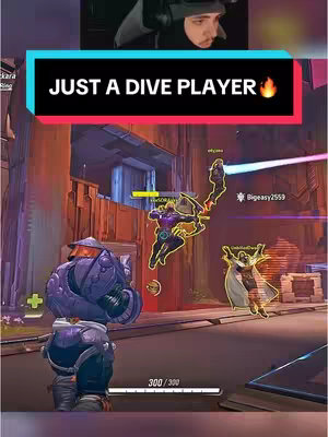 The cover image shows a split-screen layout. On top, a webcam frame displays a person wearing a black hood. Below, a frame from a video game shows action with colorful characters and environments. Text overlays are present, highlighting the video's theme.
