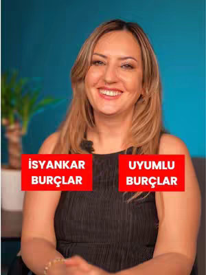 A woman with long blonde hair smiles towards the camera. Behind her is a blurry teal wall and a potted plant. Rectangular text boxes with black text on a red background are placed to her left and right.