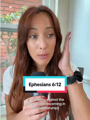A woman with long auburn hair is holding a microphone in front of her and touching her head with her right hand. Text overlays read "Ephesians 6:12" in a colorful box at the center and beneath that a description about faith in relationships.