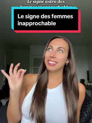 A woman with long brown hair and a white tank top is smiling at the camera with a black banner overlaid at the top with text. Her hand is up, slightly bent at the elbow, with her fingers in a pinch-like position. The background has muted, neutral tones.