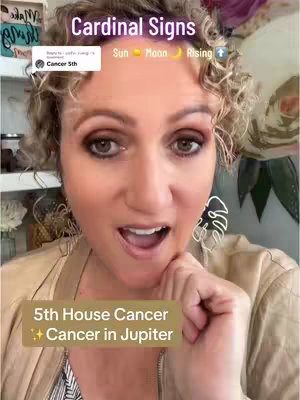 A selfie-style shot featuring a woman with curly blonde hair in a beige top, makeup with emphasized eye shadow, and a slight open-mouth expression. Text overlays include "Cardinal Signs", a comment reply box, and additional text at the bottom. The background appears lightly decorated.