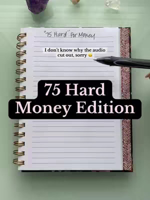 A notebook is open on a light green surface, with a spiral binding and a patterned edge on the right side.  Text overlays appear on lined paper, with the title "75 Hard Money Edition" emphasized in a black banner. Other text in a handwritten style is also present.