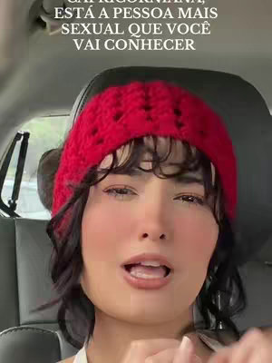 The cover image is a selfie-style shot featuring a young woman inside a car. She's wearing a red beanie and has dark hair with bangs. The woman is looking at the camera with her mouth open, seemingly speaking. The background suggests a car interior with visible headrests. The text overlay is located at the top, in a bold, white font. Her complexion is fair, and she appears to be wearing light makeup.