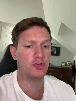 The cover image shows a man in a white shirt, facing the camera and speaking. His hair is dark brown and neatly styled. The background includes a wall, a door, and a dark wooden cabinet with a picture on top. The lighting appears to be natural, and the overall composition suggests a casual setting.