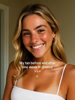 A woman with long blonde hair smiles broadly at the camera against a warmly-lit indoor background. She wears a white spaghetti strap top. The text on the screen reads, "My tan before and after one week in Greece >>>". Her tanned upper body is visible, showing tan lines from her top. She wears a gold necklace and hoop earrings. The lighting is warm.