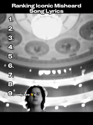 A grayscale image with a high-angle view of a grand hall with a round chandelier in the center. The hall's ceiling features decorative circular elements. The lower portion of the image shows a person with dark hair, their face partially visible, with text overlaid indicating a ranking.