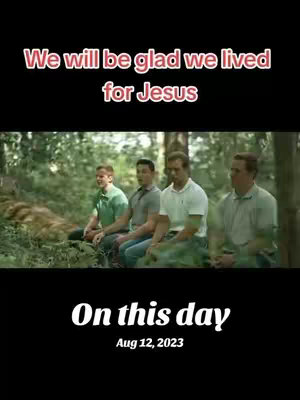 The image shows four men sitting side-by-side in a forest setting. They appear to be engaged in a calm, perhaps reflective moment. Text overlays, including the date, add context.