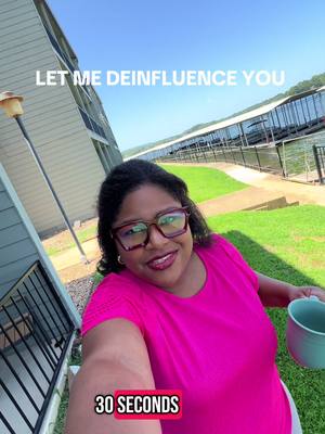 A selfie-style video cover. A woman with glasses and pink shirt is holding a mug, in front of a waterside background that is a bright sunny day. Text overlays read 'LET ME DEINFLUENCE YOU' and the bottom of the image reads '30 SECONDS' in a pink box.