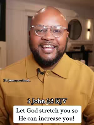 A medium shot features a man with glasses, a bald head, and a beard, smiling at the camera. He wears a mustard-yellow shirt with a small microphone clipped to it. Below him is a text overlay with a bible verse.