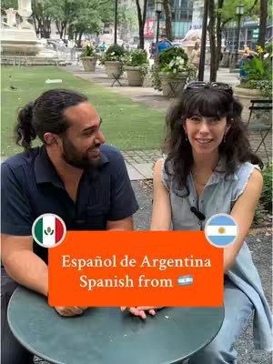 A video cover image featuring two people seated at a table in what appears to be a park setting. The background has a green field and out-of-focus trees. An orange rectangular text box, overlayed on the image, reads "Español de Argentina" and "Spanish from" with the Argentinian flag emoji. The figures are smiling, suggesting a friendly and informative interaction, and the flags of Mexico and Argentina are placed on the bottom left and right respectively, possibly indicating content related to different Spanish dialects.