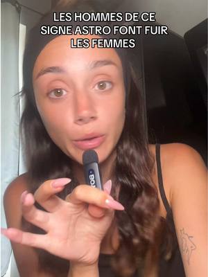 A young woman faces the camera, holding a black microphone. She has dark hair pulled back with a black headband and is wearing a black tank top. Text overlays the image.
