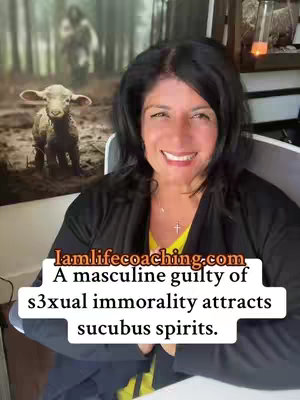 The cover image shows a woman smiling and looking at the camera. She has dark hair and is wearing a black top with a yellow shirt underneath. Behind her is a blurred background with a painting of a lamb and a person. The text overlayed on the image has url and a message about masculine guilt attracting succubus spirits