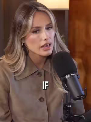 A woman with blonde hair, wearing a tan jacket, is centered in the frame with a dark microphone to her right. The text "IF" is overlaid on the bottom part of the image.