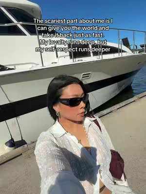 A woman stands on a dock with a luxury boat in the background, a poetic quote overlayed