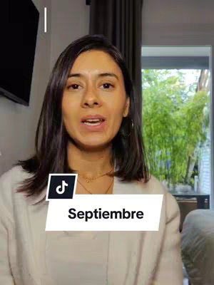 A woman with dark hair is in the frame, centered and looking towards the camera, with an off-white jacket. Behind her is a window providing natural lighting and a glimpse of an outdoor green space. At the bottom left corner, a TikTok logo is placed, with the word "Septiembre" in a white rectangular box overlayed.
