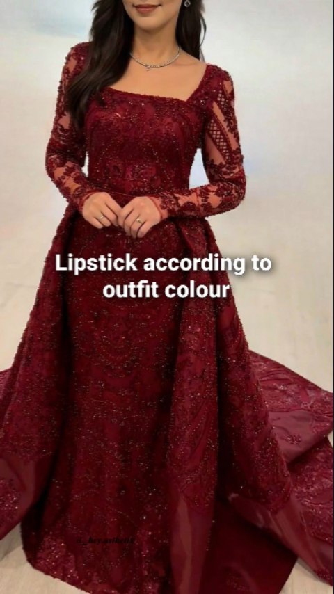 A woman in a long, red, beaded evening gown is shown. The dress has long sleeves, a square neckline, and a train. The text overlay reads "Lipstick according to outfit colour".