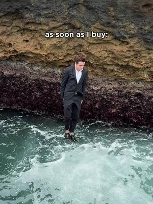 A man in a suit seemingly standing on water near a rock cliff face. Text overlayed above the man reads "as soon as I buy:"