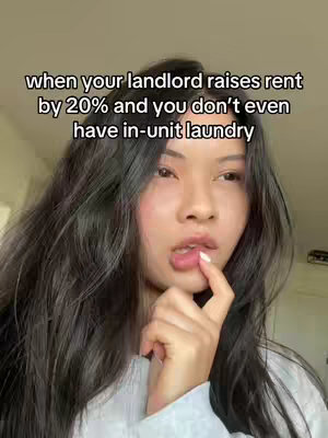 A woman is looking pensively towards the right side of the frame, biting her index finger, with a black text overlay. The woman has dark hair, styled down, and is wearing a white top. The background softly blurred. The text is white with a black outline and positioned to the upper left, addressing a common housing problem.