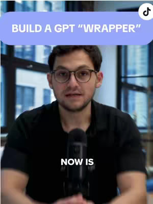 A man with glasses and a black shirt is centered in front of a microphone, with a text overlay at the top and bottom.