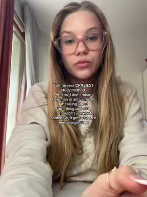 A young woman with long blonde hair and pink-framed glasses is centered in the frame, looking directly at the camera with a neutral expression. Text overlays are placed over her image. The background appears to be a home interior with a window and curtains visible partially on the left. The overall composition has a casual, personal feel.