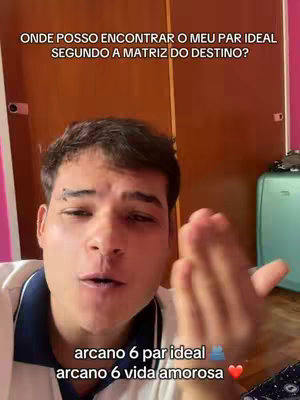 A young man is centered in the frame, giving a direct gaze towards the camera. Behind him is a warm-toned wooden door and a glimpse of a room. Overlay text provides information about the video's topic, set against a backdrop of a room with a light green luggage.