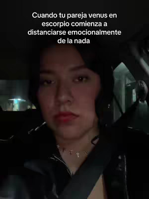 The cover image shows a woman in a car, looking directly at the camera with a somewhat serious expression. She has dark hair and is wearing a black jacket and a necklace with cross pendants. The interior of the car is visible, with a seatbelt across her chest.