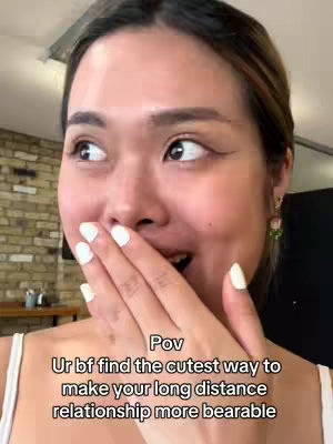 A young woman closes her mouth with her hand, looking to the side with a surprised expression. Overlay text is present at the bottom.