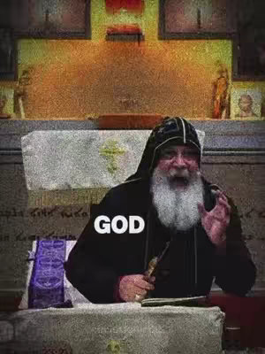 An elderly man with a white beard in a dark hooded robe is positioned in front of a stone structure, possibly an altar, with artwork in the background. The text 'GOD' is superimposed over the image.