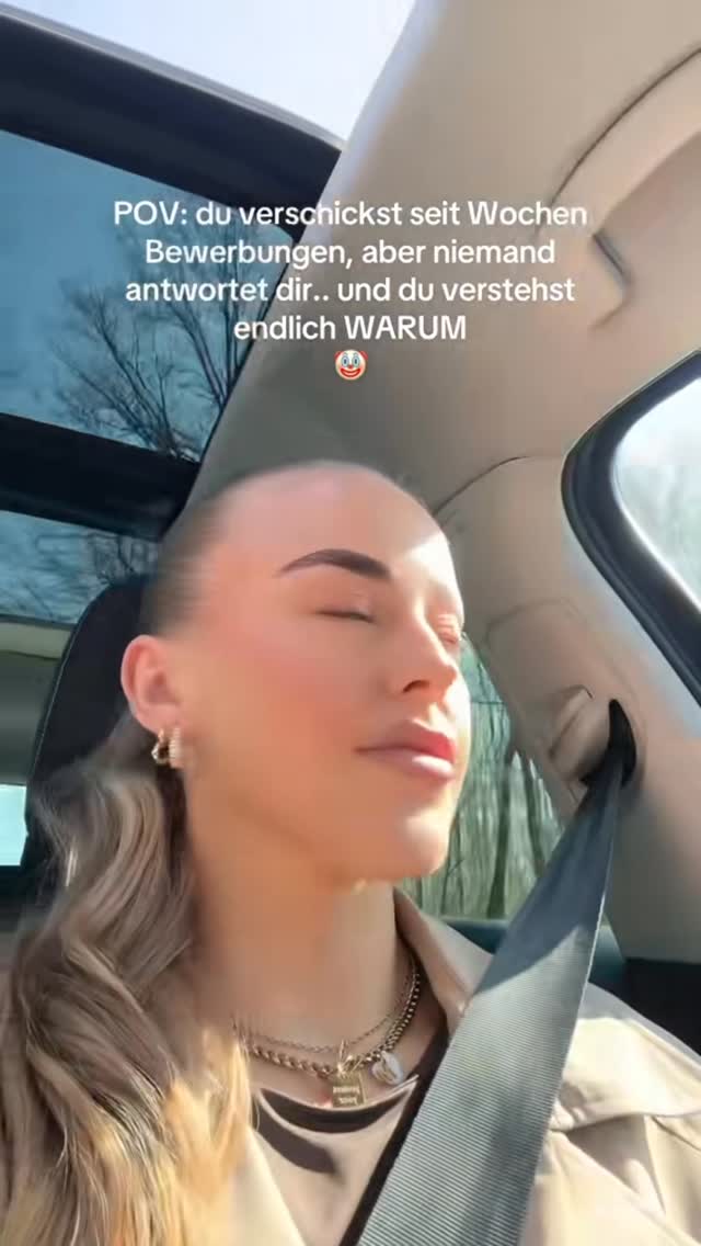 A selfie-style shot captured inside a car, focusing on a woman's face. She's positioned at a slight angle, with a soft, blurred background suggesting movement or speed. The lighting is natural, casting soft shadows. The woman has her eyes closed, her expression serene. The upper portion of the frame features text overlayed on the image.
