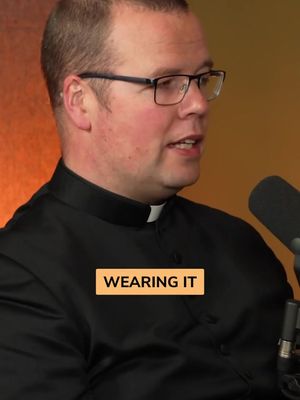The cover image features a man wearing glasses and a dark shirt with a white collar, likely a priest, speaking into a microphone. An orange rectangle with the text 'WEARING IT' is placed on his chest.