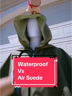 The cover image displays a mannequin wearing a green cloak, with a red rectangle overlay containing the text 'Waterproof Vs Air Suede'. The background shows a partial view of a building with white doors.