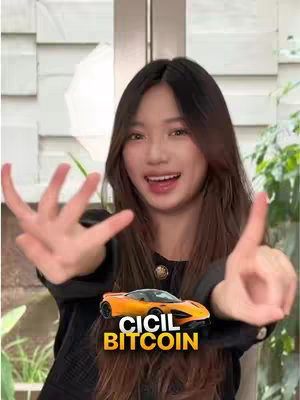 A young woman with long, dark hair is posing in front of a light-colored background, possibly a door or wall. She is smiling and making a hand gesture with her fingers spread wide, as if counting or demonstrating something. In front of her, superimposed over her body, is a small toy car. Above the car, yellow text reads 'CICIL BITCOIN'.