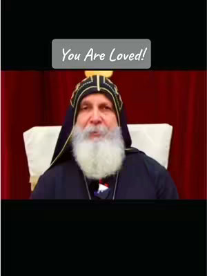 The image features a man with a white beard, wearing a dark robe and a hat with a yellow trim. The words “You Are Loved!” appears in a framed text overlay above the man.